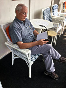 Man using booklight on Shaw porch