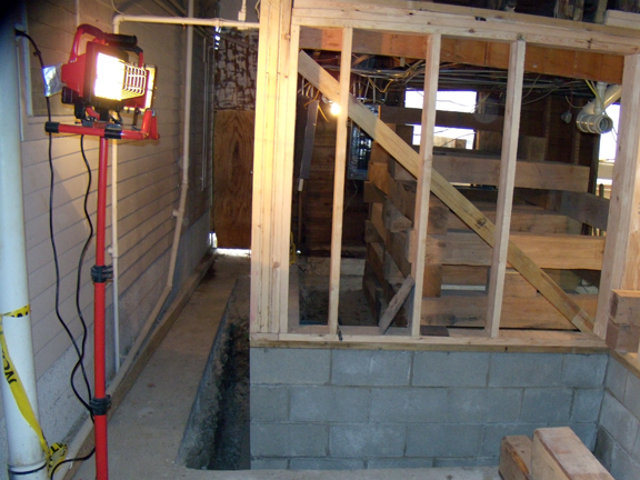 February 16, 2010. Same view as Photo 4A but two weeks later. The footing and block foundation are in, with 2x6 studding on top, ready for sheathing.