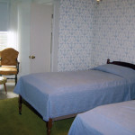 Shaw house room showing beds and chair