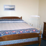 Shaw house room showing bed and chair