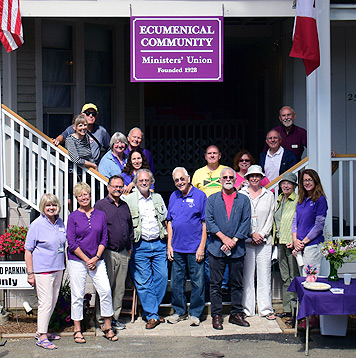 Group photo in front of Shaw House during porch blessing