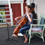 Cellist playing on Bird-Werner porch during porch blessing dedication