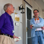 Jack Knepp and Bob Tupaj visiting on Shaw porch during porch lessing ceremony