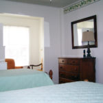 Shaw house room showing beds, dresser and window