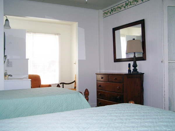Shaw house room showing beds, dresser and window