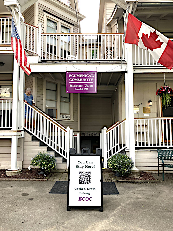 front view of the ecumenical community of chautauqua with sign in front with you can stay here gather grow belong ecoc