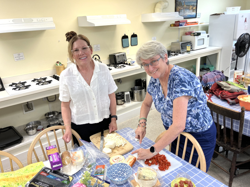 Two women in Shaw kitchen preparing a meal