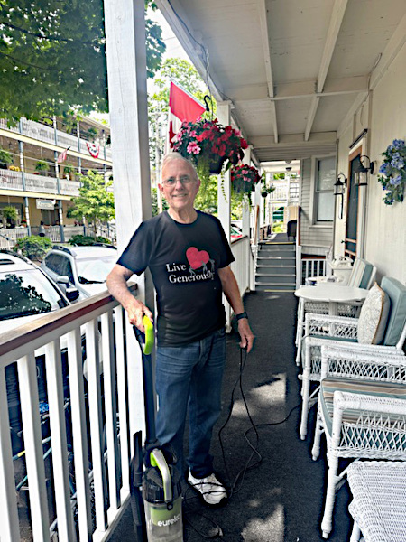 reverend david matthews cleaning shaw house porch during a work weekend